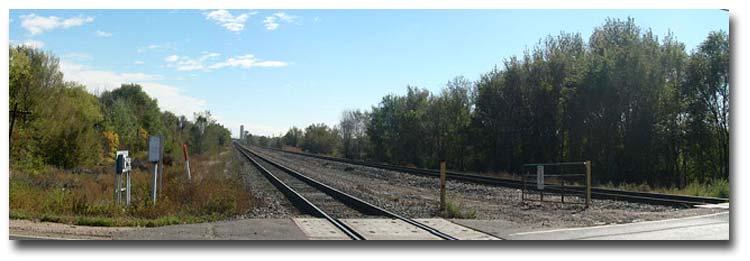 Large industrial properties generally surround the tracks throughout the section, with the exception of some large vacant areas and a few residential properties.