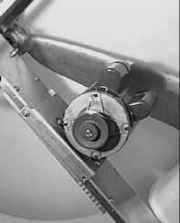 Remove the Self Tension Motor Mount by loosening the two Swivel Bolts (5/ 16" Carriage Bolts).