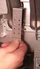 Using a 5/16 wrench, nut driver or screw gun bit, remove all burners by removing the (2 ea.