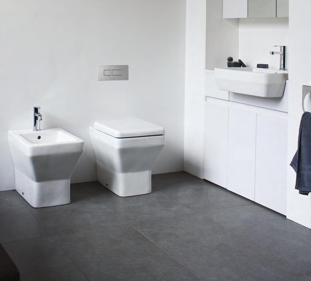 Cube back to wall bidet with Crystal bidet mixer with pop-up waste. Cube back to wall WC with Carbamide soft-close seat and concealed cistern with flush plate.