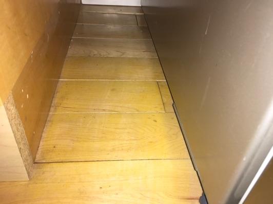wood flooring to the left of the refrigerator