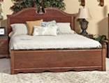 B164 Naralyn Traditional design in a reddish brown replicated cherry grain Features broken pediment style mirror and headboard design Antique gold metalized trim on edges of drawers, mirror, and bed