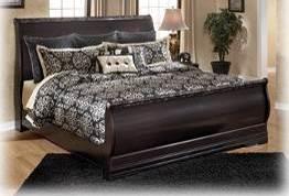 B179 Esmarelda Replicated mahogany grain in a dark merlot finish Sleigh bed and storage footboard bed available in this group Deeply