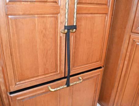 SECTION 4 APPLIANCES AND SYSTEMS Refrigerator/Freezer Travel Strap If Equipped Attach one end of strap to both Refrigerator door handles and the other end of strap to the Freezer door handles (as