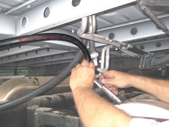 Assemble coolant ports to the unit before carefully lowering it between the frame rails.