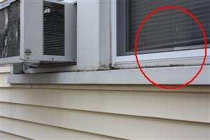 Page 7 of 70 1.5 Picture 4 1.5 Picture 5 (3) Propped up AC units are damaging window sills and window trim.