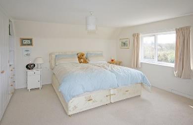 8 x 4m/15 9 x 13 1 The second upstairs bedroom features large north and west-facing picture windows towards Alderney and Guernsey, newly fitted wardrobes and bookshelves, a panel central heating