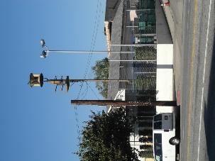 3S;3CS;5S3 Air raid siren; wire spool type on a freestanding pole; associated with World War II and Cold War military infrastructure. West side of Figueroa St.