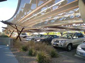 If a parking structure is well designed and integrated to other uses, it does not need to be screened by dense landscaping in an urban setting.
