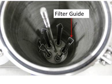5. Remove the cup and spring assemblies from the tops of the filters then