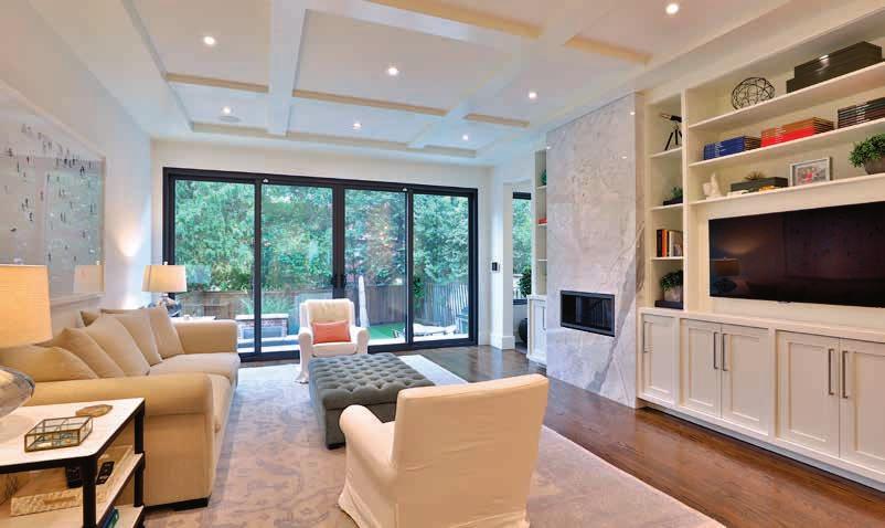 MAIN FLOOR Family Room Gas fireplace with marble slab surround Custom built-in shelves and cabinetry High, waffled
