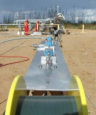 Casing conveyed optical fiber is deployed into a standard hydraulic control line while in-situ.