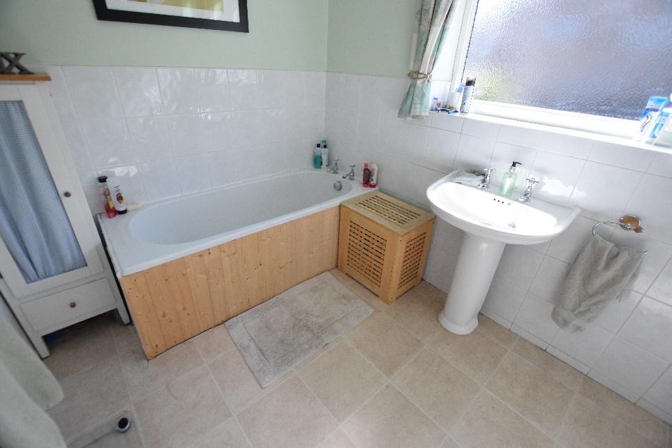 FAMILY BATHROOM Having three piece suite in white comprising of low flush WC, hand basin