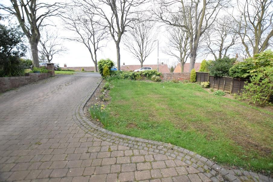 OUTSIDE Cobbled driveway and path leading to large garage having automatic door, power and