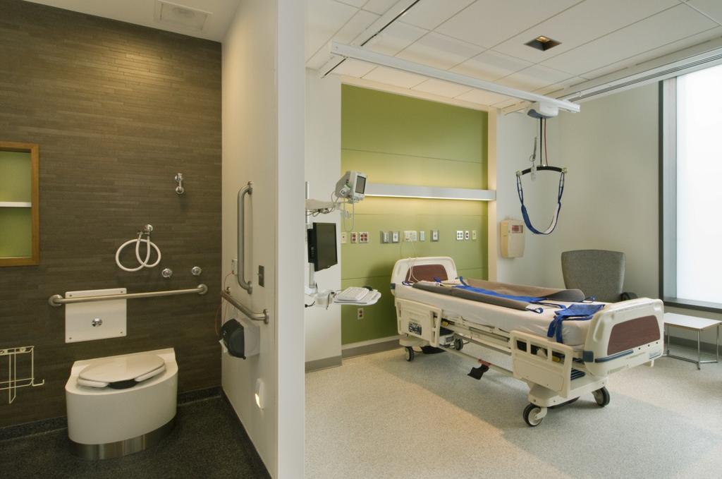 As identifiers for the four quadrants of the emergency care zone, bold color was applied to nurse stations composed of backlit-resin panels and Corian counters.