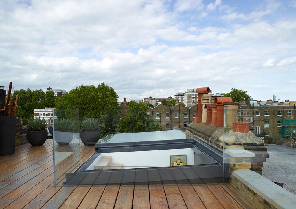 Bespoke sliding over roof unit including wall abutment detail, used for terrace access in London property.