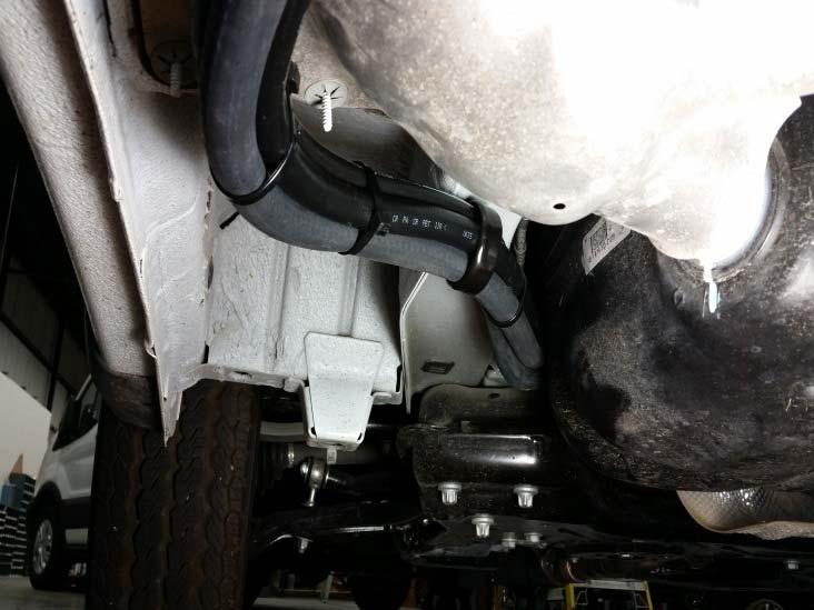 Route hoses and harness through holes to under vehicle Attach supplied bracket to heat