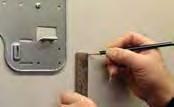 Angle the drill with a downward pitch to the outside wall so that the outside hole will