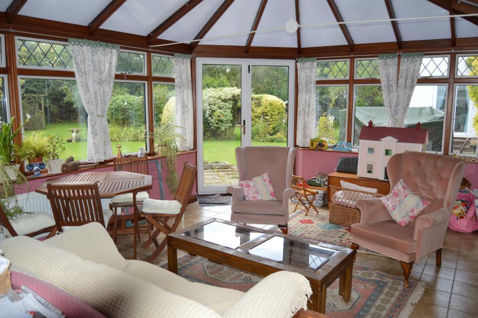 Conservatory: measuring approximately 13 8 x 20 0 (4.20m x 6.09m) with ceramic tile floor covering, constructed with hardwood frame and double glazed panels. Ceiling fan with lights.