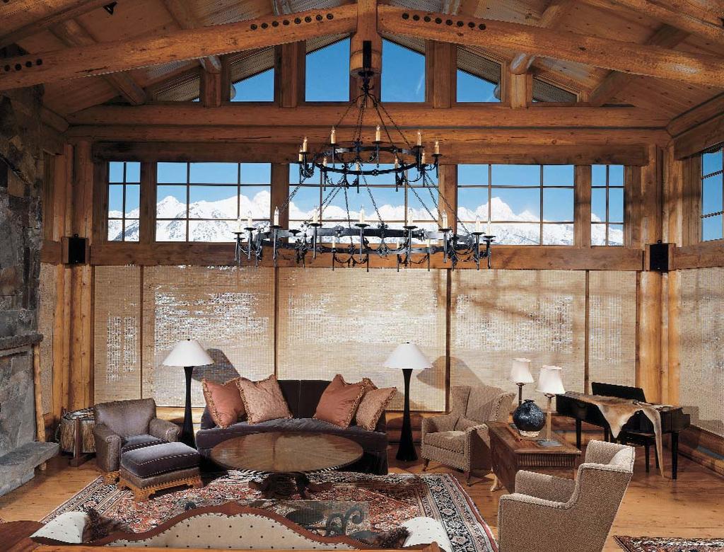 Woven wood shades compliment the rough-hewn timber and stone surfaces in this mountain home.