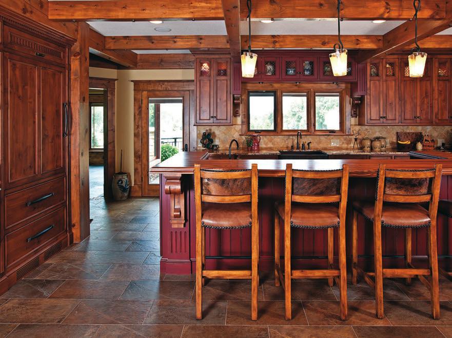 Wood and granite countertops accent the kitchen s distressed alder and red cabinetry.