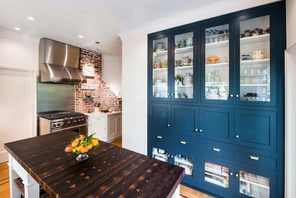 After the custom china cabinet painted a bold dark blue adds