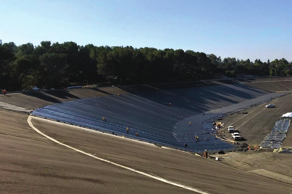 FIGURE 5 Slope covered with geocomposite and CSPE geomembrane liners installed at seam overlaps to guard against pinhole leaks. Every 8 miles (13 km) of liner cap strip must be tested.