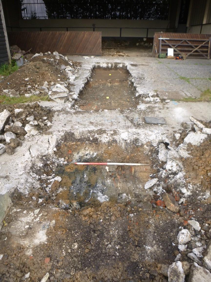 Modern concrete surface F4, similar to that of F1, was uncovered midway along the trench. Possibly underlying F4 was F5, a post-medieval/modern gravel surface consolidated with peg-tiles.