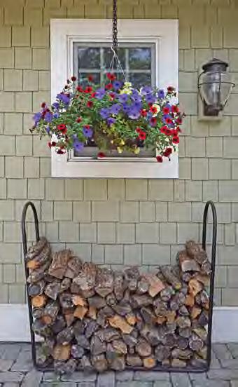 A cheery, colorful flower planter accents the home s exterior, along with a neatly stacked pile of firewood. Flowers planted in a bird bath add a beautiful finishing touch to exterior spaces.