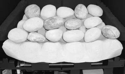 1 FUEL BED LAYOUT - Pebble effect option This fire is supplied with 15 ceramic pebbles. The pebbles may vary slightly in size, shape and colour, in order to allow a realistic layout.