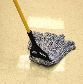 8 Liberally apply stripping solution to the floor. Dip the mop into the stripping solution.
