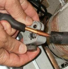 Pull back insulation and cut the copper tube with a tubing cutter.