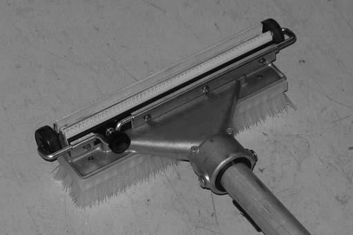 Squeeze the solution lever on the power wand to spray solution onto the floor. Scrub the floor with the brush side of the cleaning tool.