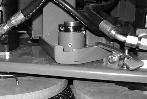 The torque tube grease fittings on the operator side of the machine are located beneath the fuel tank.