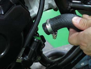 Slide up the clamp and free the coolant hose from the