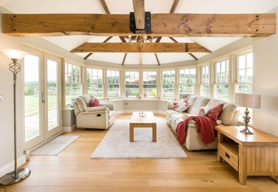 ceilings with exposed beams, solid oak flooring and private gardens benefiting from far-reaching views. The front door opens into a bright hall which has windows to either side.