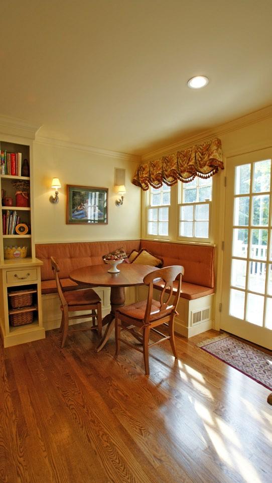 The adjoining breakfast area features built-in bench seating and storage shelves.