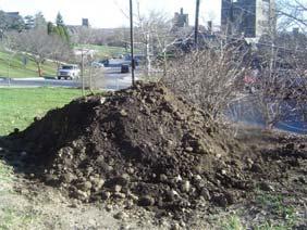 Begin shaping soil by mounding soil, and tamping or using shovels.