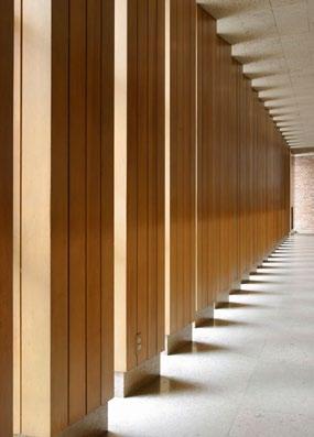 Wood screen louvers are positioned to allow light to warmly illuminate the