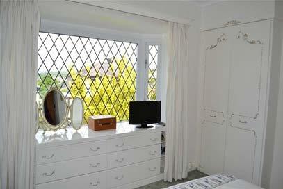 wardrobes providing hanging and storage space, built in drawers into the