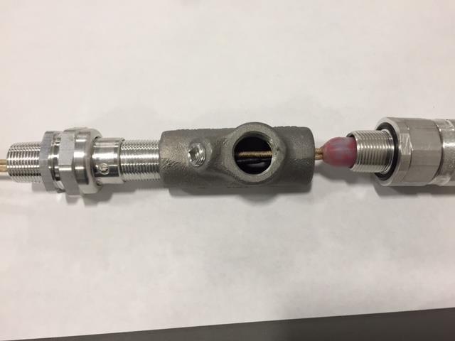 hanging out the end along with the remaining stripped cable. Push heater Strain Relief Grommet into place and tightly connect strain relief fitting to the sealing fitting. 2.