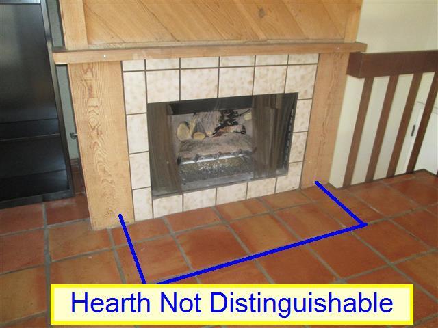 The tile at the front of the fireplace did not display a distinguishing feature.