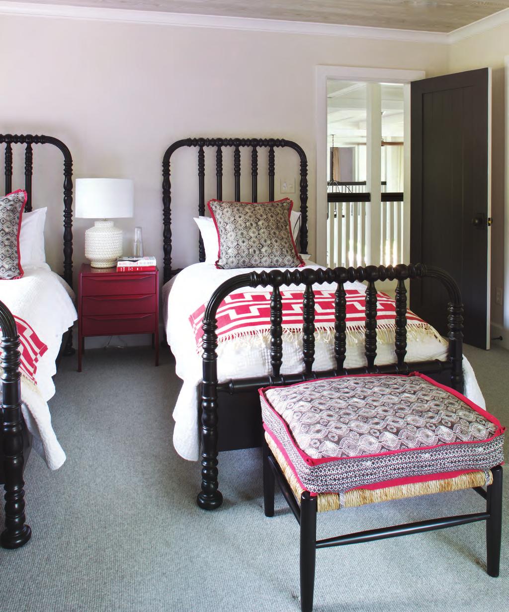 Double The Fun One guest room is furnished with twin beds from Noir Furniture. Lexington Clothing Company throws complement a Redford House ottoman in an Osborne & Little fabric.