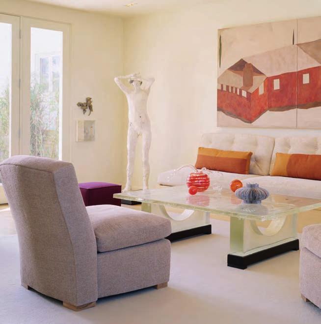 Above: Accents in the living room pick up hues in the art over the sofa and are easily adaptable should the clients choose to exchange the painting for another.