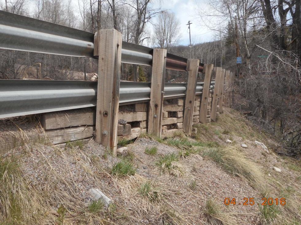Figure 2 Timber Cribbing Wall and Guardrail System Within Red Mountain Ranch, there is a short section of concrete wall along Sabin Drive near the property s driveway that protects the