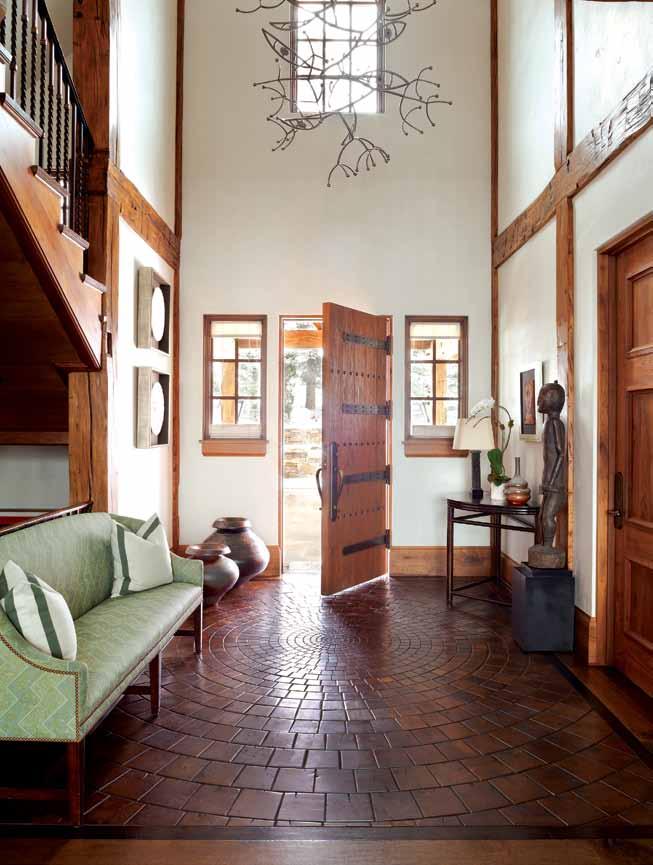 Opposite: The light-filled, twostory foyer features a crosscut oak floor that resembles terra-cotta tile.