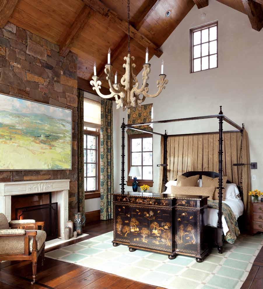 The high-ceilinged master bedroom features a made-to-order Rose Tarlow chinoiserie chest that conceals a pop-up television.