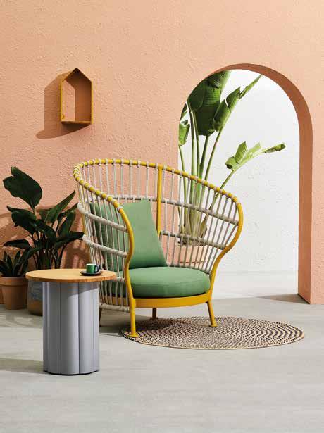 NEST (KC8602) high-back lounge chair in Curcumin/Sand; cushion in Leaf. LOTUS (KT8602) side table in Silver Grey/ teak top Ф48 54cm. PETITE MAISON (KH8502) candleholder.