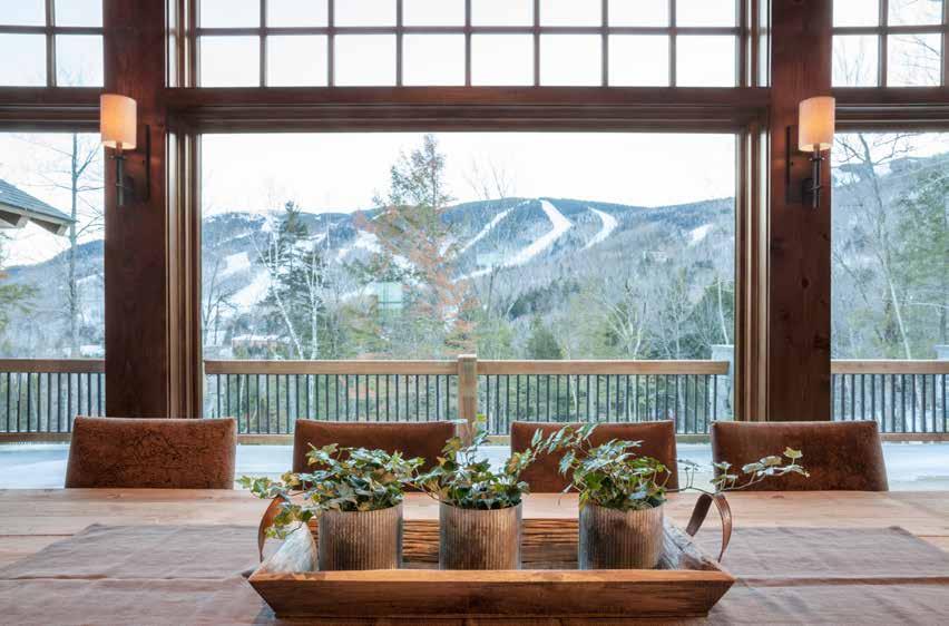 A view from the dining room to the trails of Sunday River (above). The table and straight-back leather chairs are from Restoration Hardware.