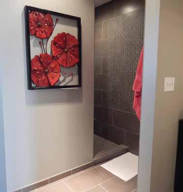 This walk-in shower was designed without a door or glass by Von Tobel Lumber & Hardware. There is space for a seat and grab bars.